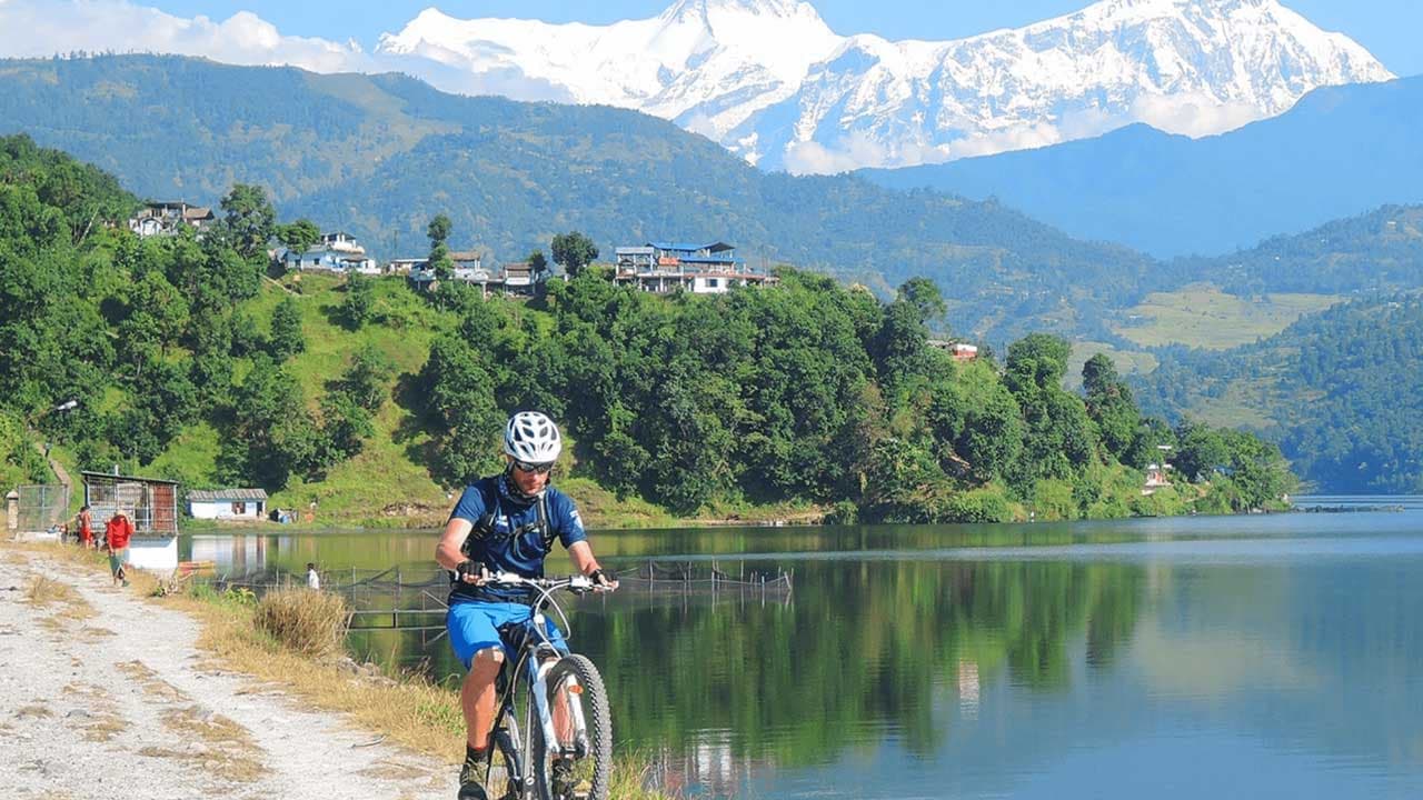 Cycling on the road beside Begnas Lake